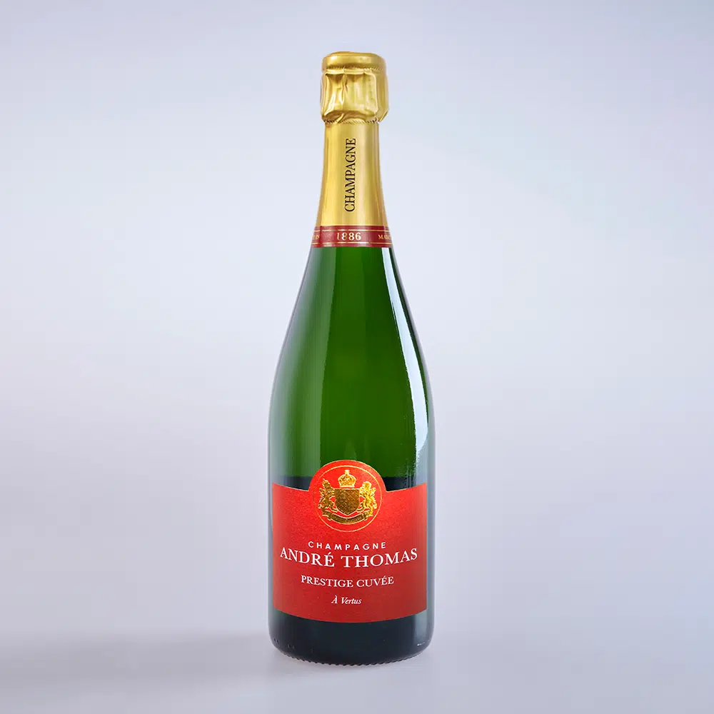The photo shows a bottle of Andre Thomas champagne from Saint Sauveur